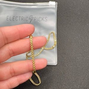 Electric Picks. Gold necklace.